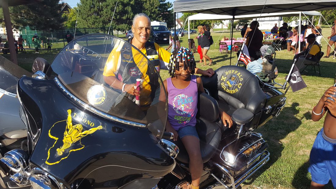A man and a girl sitting on a motorcycle